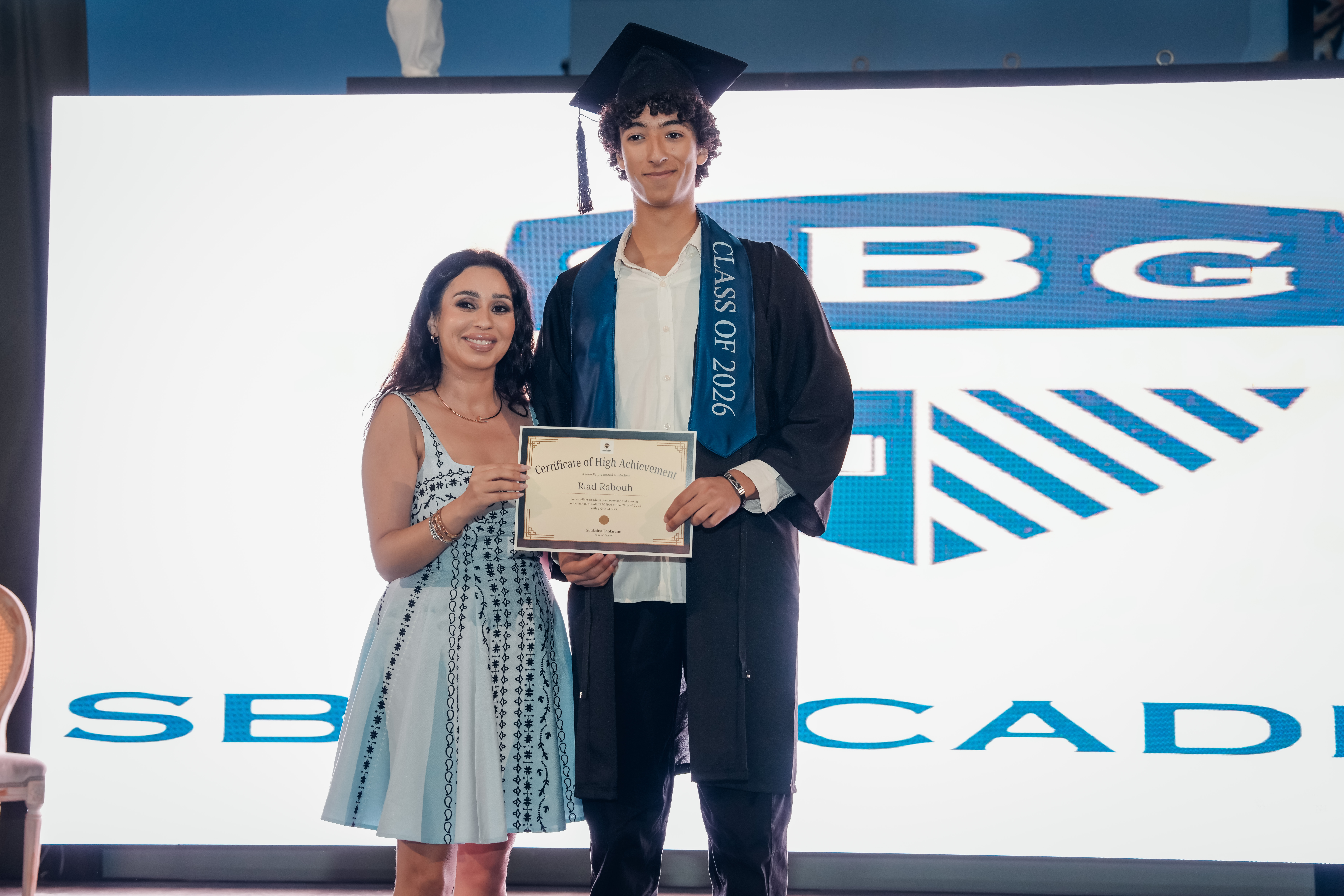 SBG Academy graduate holding her diploma folder