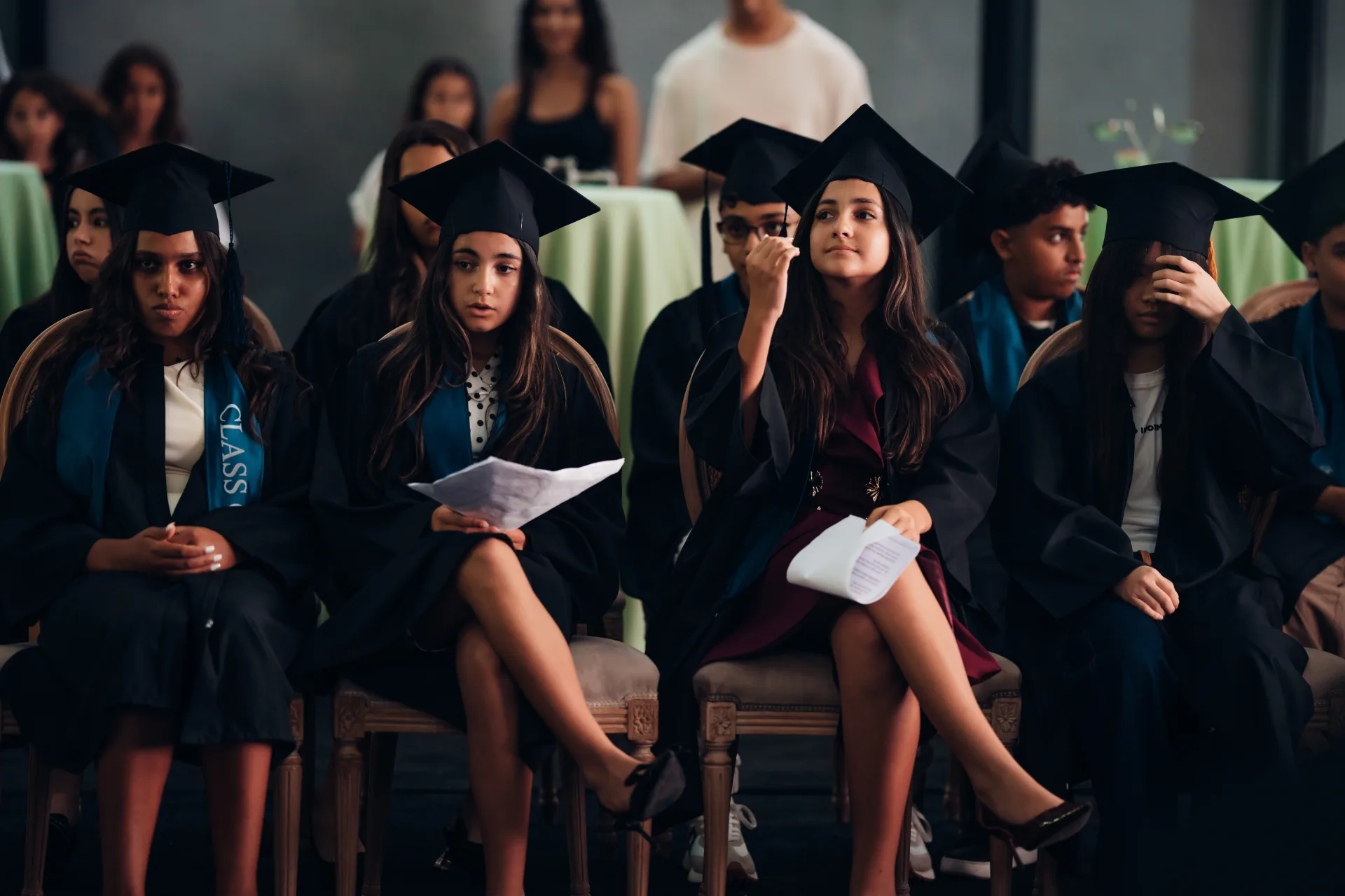 SBG Academy students seated together in graduation caps and gowns