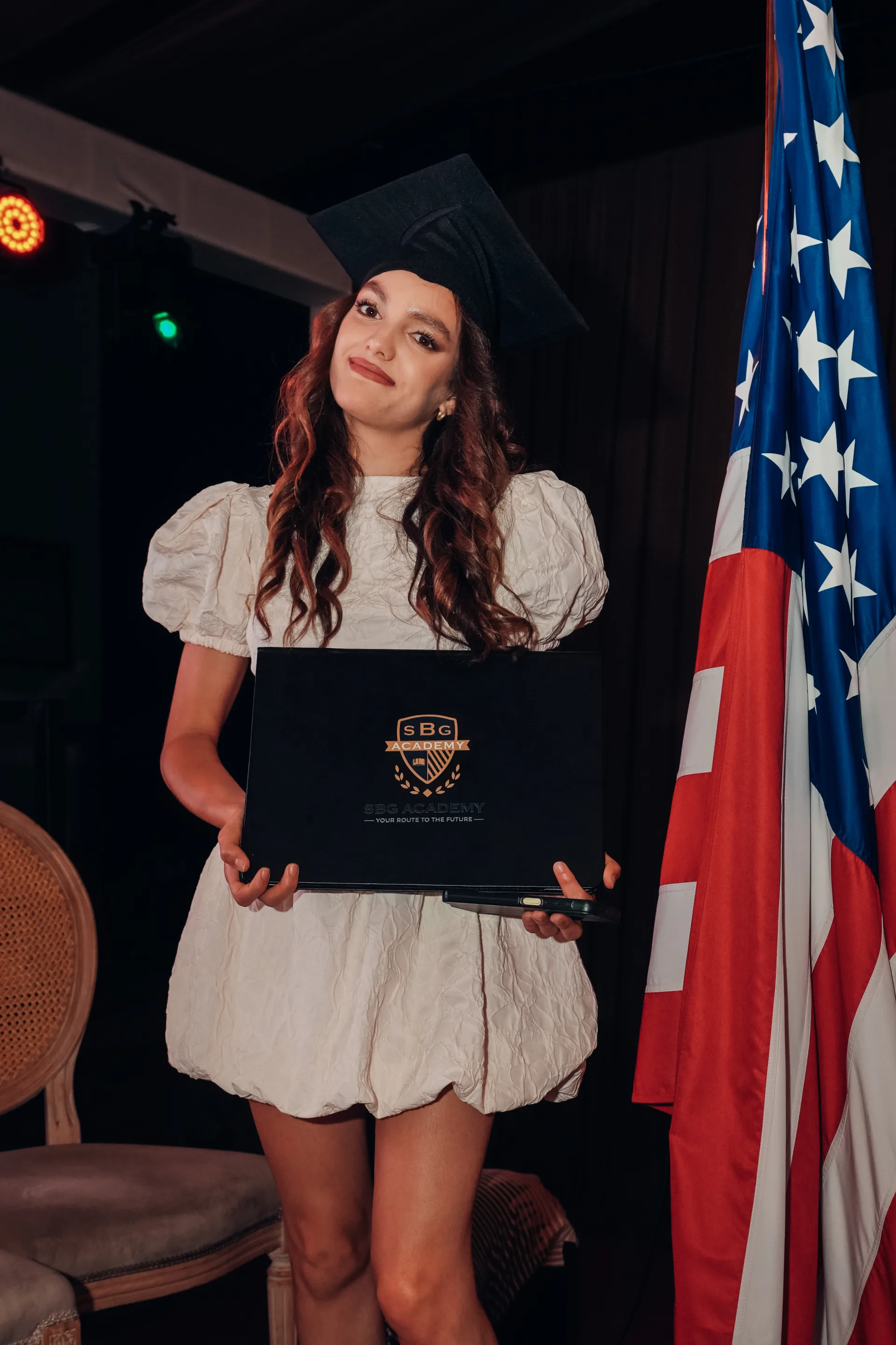 SBG Academy graduate holding her diploma folder