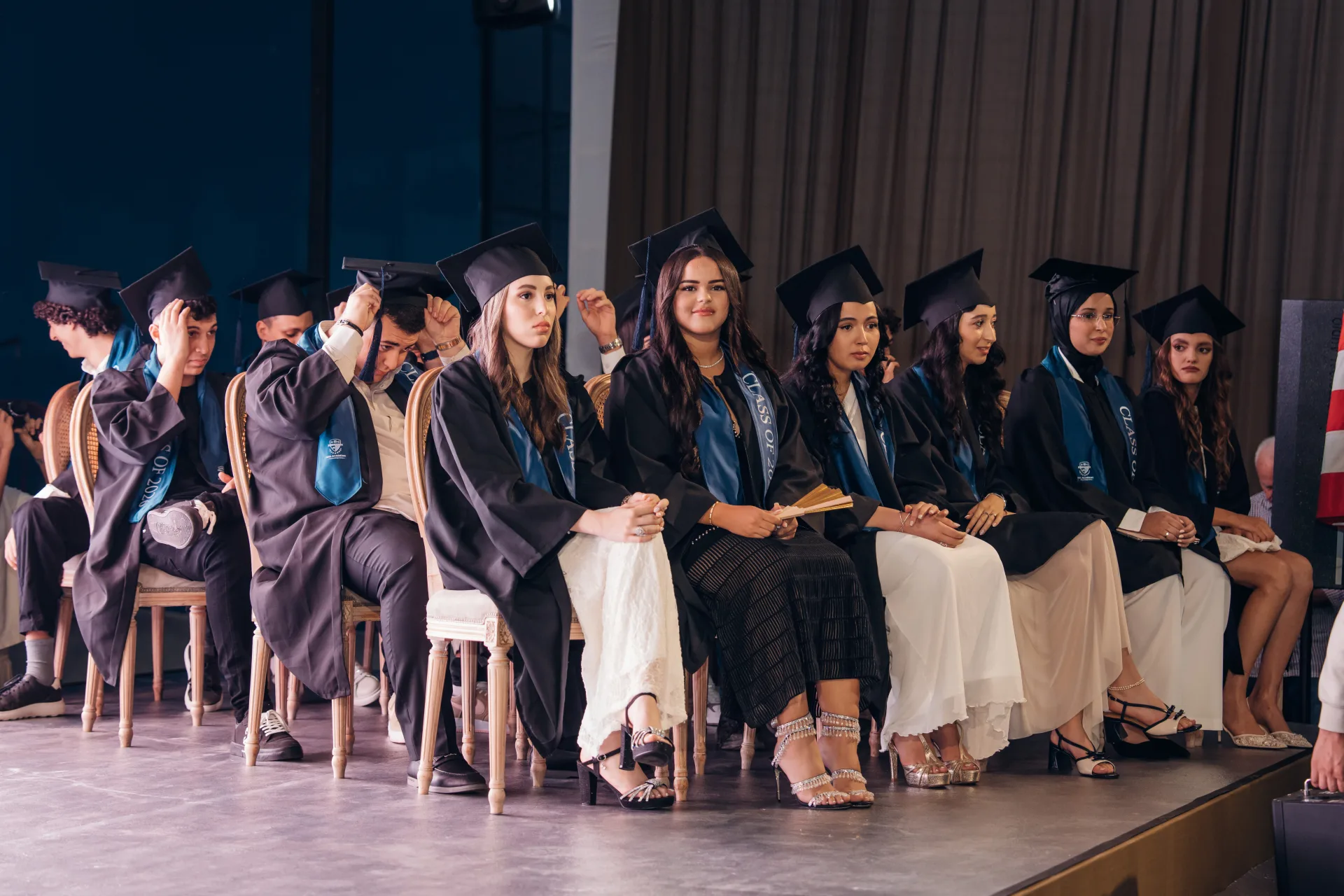 SBG Academy graduates seated on stage